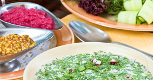 Summer kvass soup (okroshka) on served table with ingredients